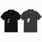 Two Polo Ralph Lauren short-sleeve polo shirts shown side by side on a white background: one white with black piping and a black embroidered pony logo, and one dark gray with white piping and a small dark logo.